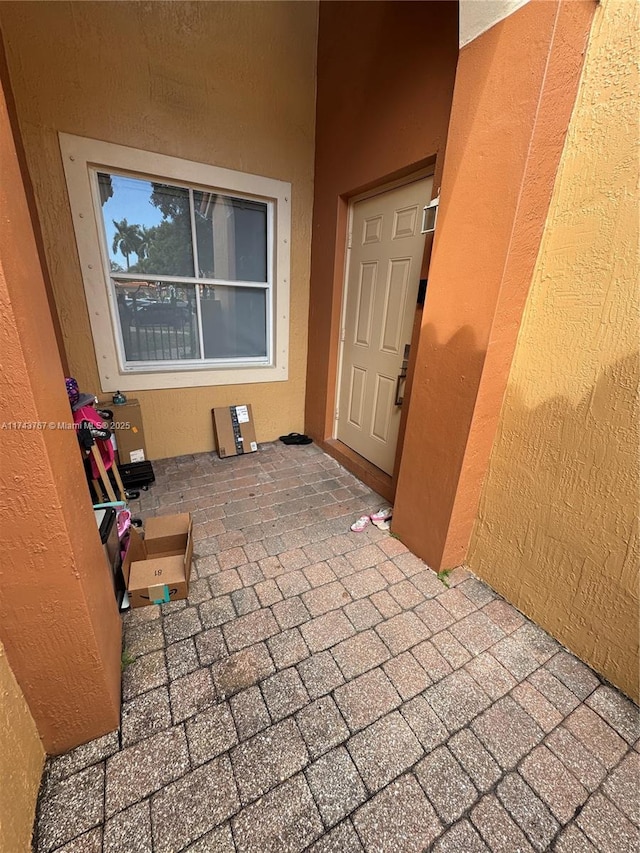 property entrance featuring a patio area