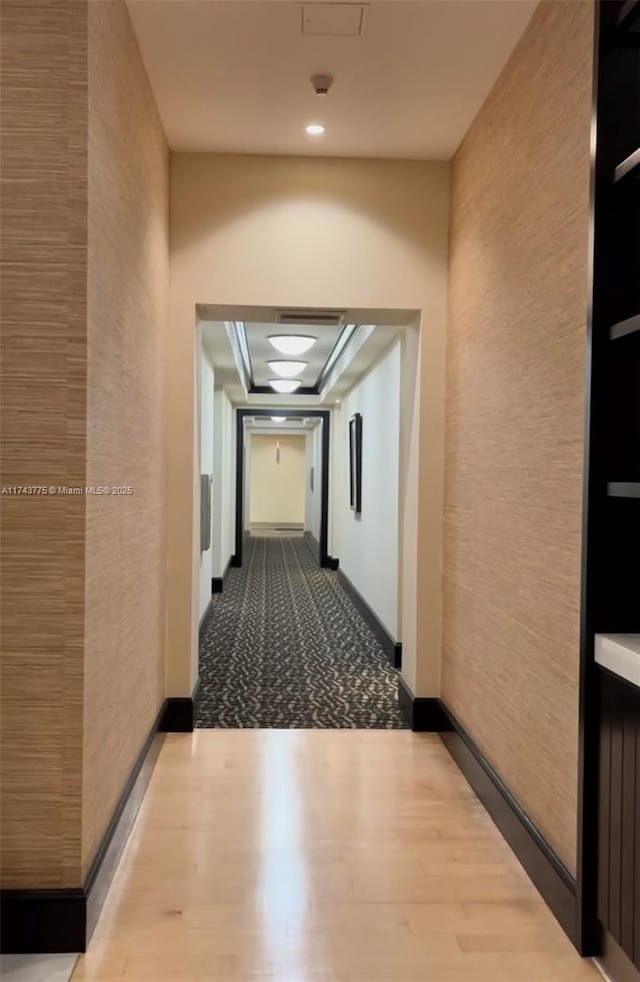 corridor with light hardwood / wood-style flooring