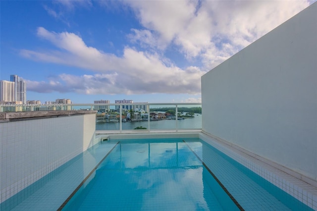 view of swimming pool with a water view