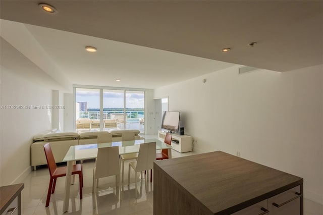 dining room with light tile patterned floors and expansive windows