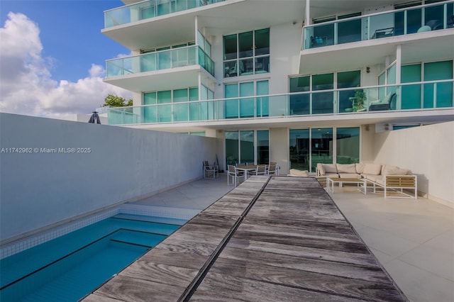 view of pool with outdoor lounge area and a patio