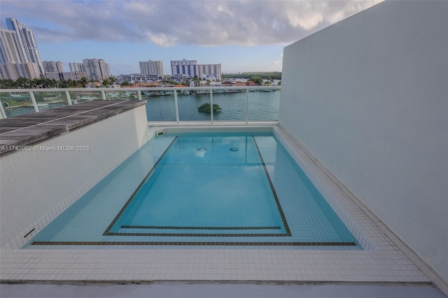 view of swimming pool with a water view