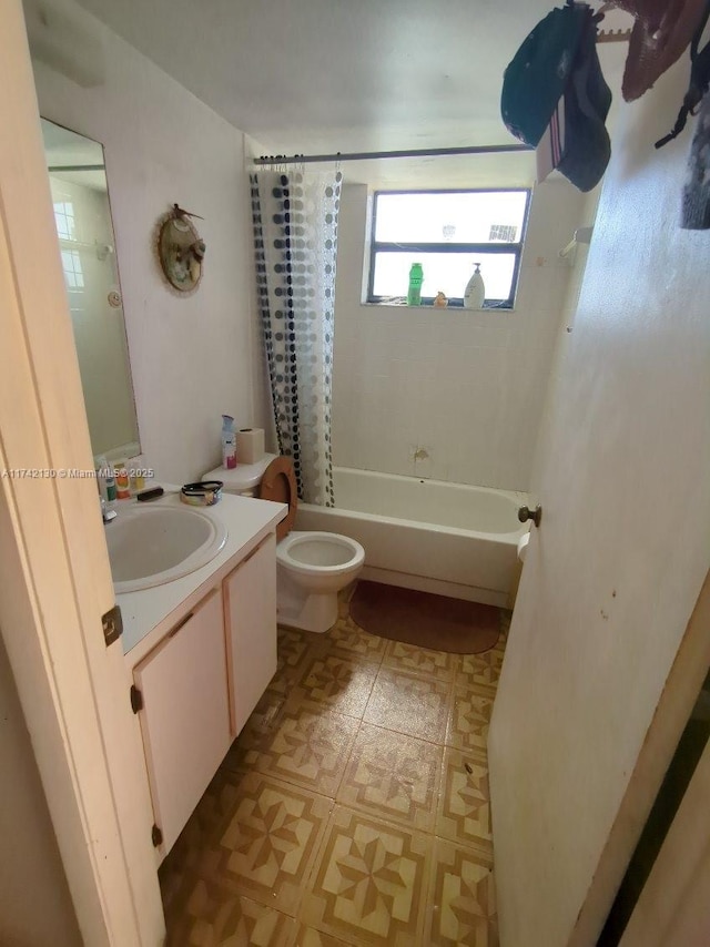 full bathroom with vanity, shower / tub combo with curtain, and toilet