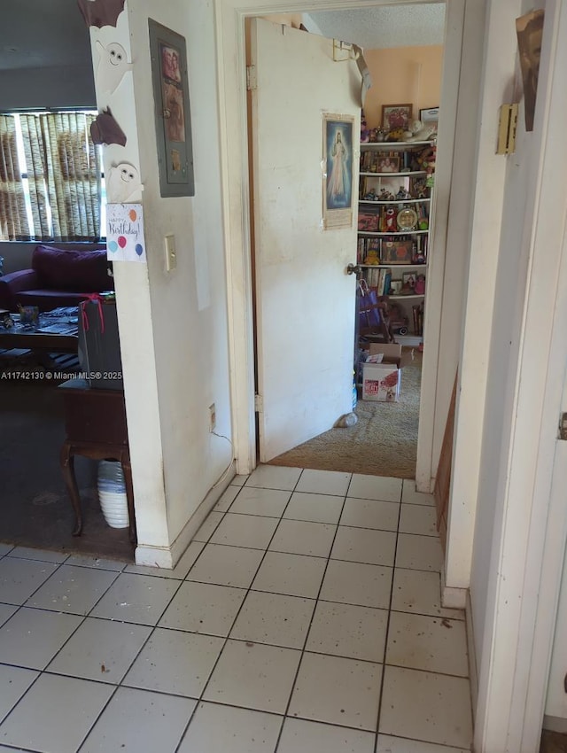 hallway with tile patterned floors