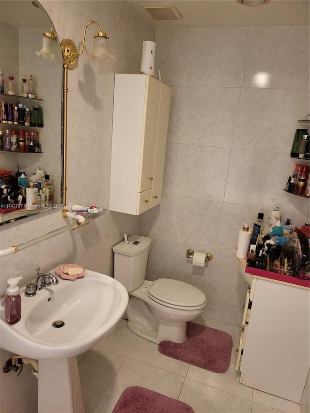 bathroom featuring tile patterned flooring and tile walls