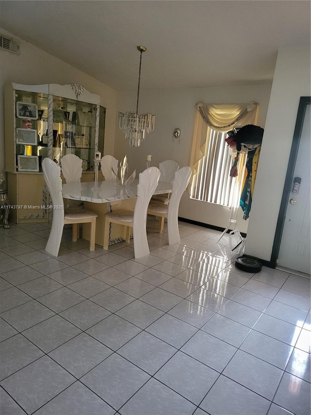 unfurnished dining area featuring light tile patterned floors and a notable chandelier