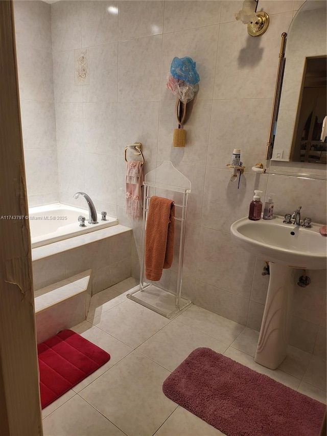 bathroom featuring tiled tub, tile walls, and tile patterned floors