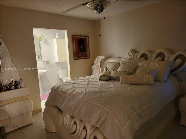 tiled bedroom featuring a textured ceiling and ensuite bathroom