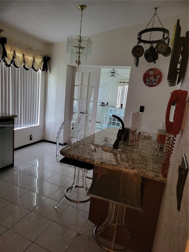 tiled dining area featuring vaulted ceiling and ceiling fan