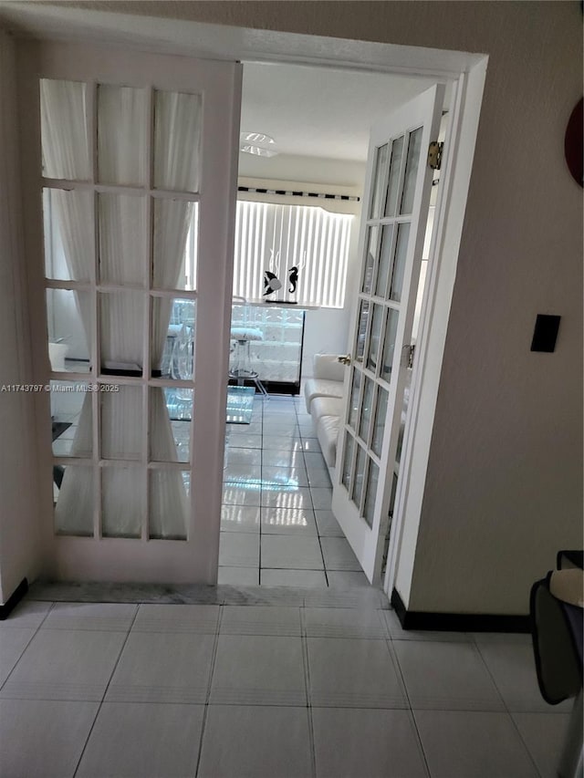 interior space featuring light tile patterned floors and french doors