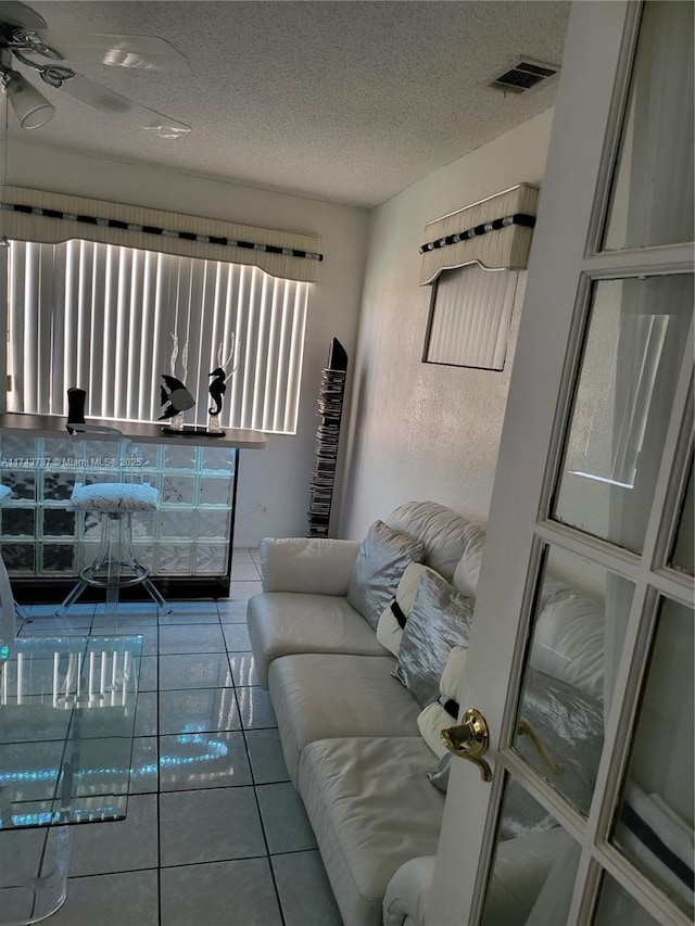 tiled living room with a textured ceiling