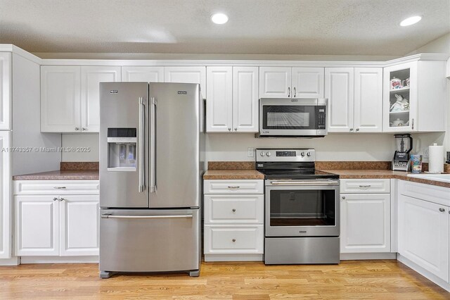 4149 S Pine Island Rd, Davie, FL 33328 - kitchen featuring white cabinetry, light wood-style floors, and stainless steel appliances