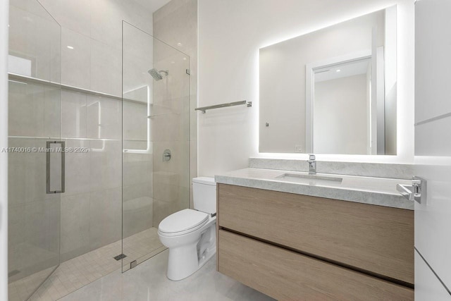 bathroom featuring vanity, an enclosed shower, and toilet