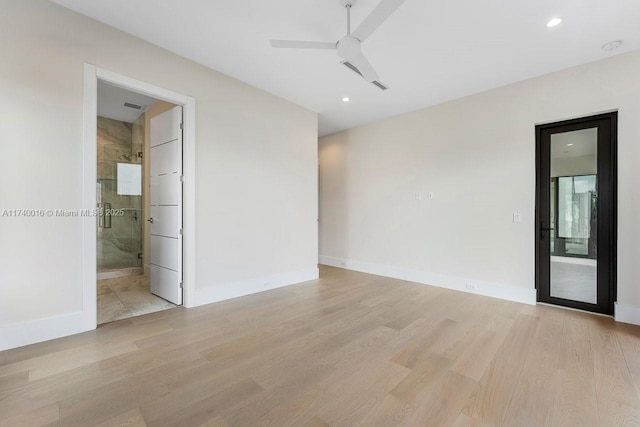 spare room with ceiling fan and light wood-type flooring