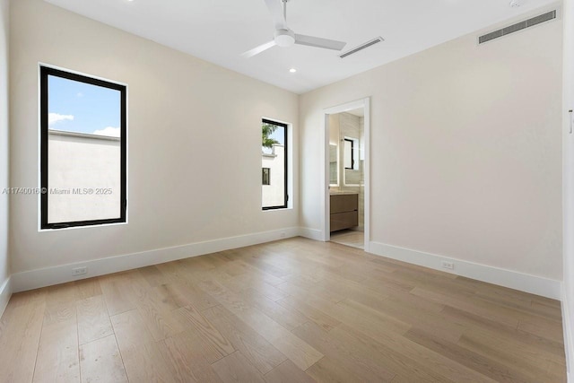 unfurnished room featuring ceiling fan, light hardwood / wood-style floors, and a healthy amount of sunlight