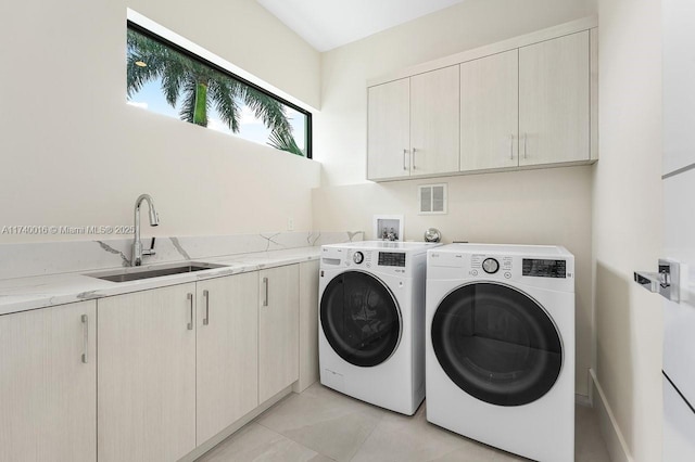 washroom with cabinets, sink, light tile patterned floors, and independent washer and dryer