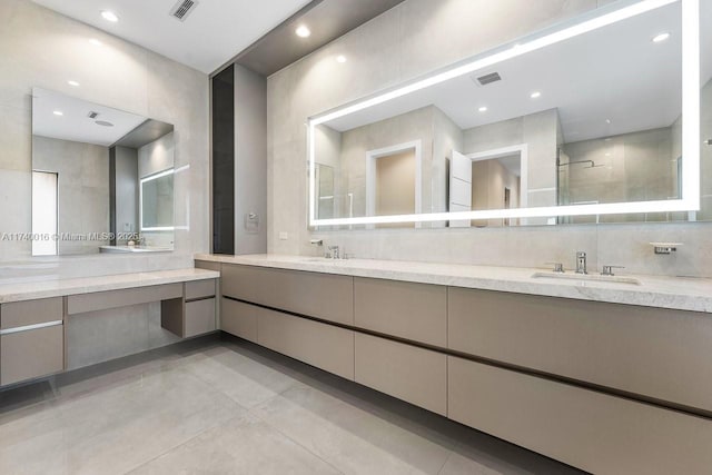 bathroom with tasteful backsplash, vanity, and a shower