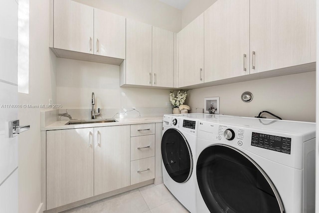 laundry area with separate washer and dryer, sink, light tile patterned floors, and cabinets