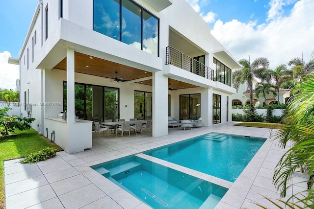 rear view of house with a patio, a balcony, an outdoor hangout area, and ceiling fan