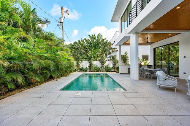 view of pool featuring ceiling fan and a patio