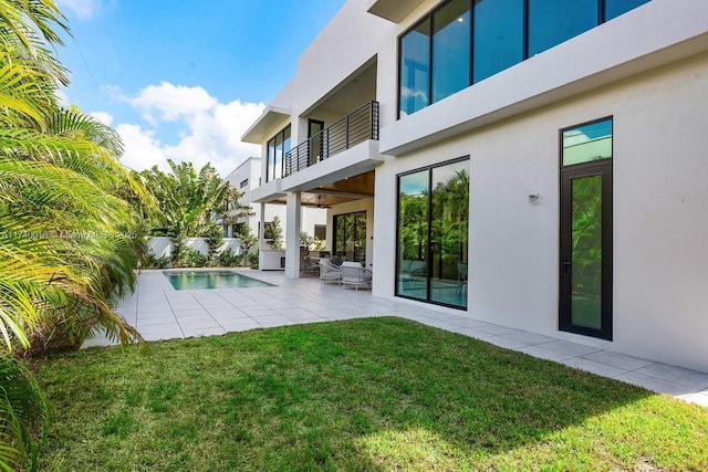 exterior space with a patio area and a lawn