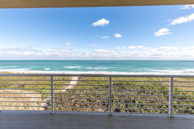 balcony with a beach view and a water view