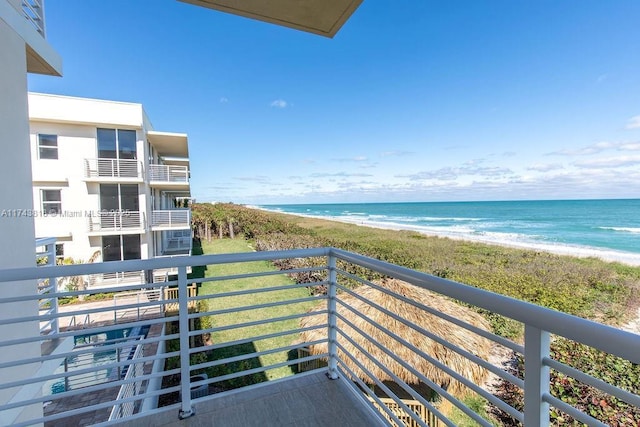 balcony with a water view and a beach view