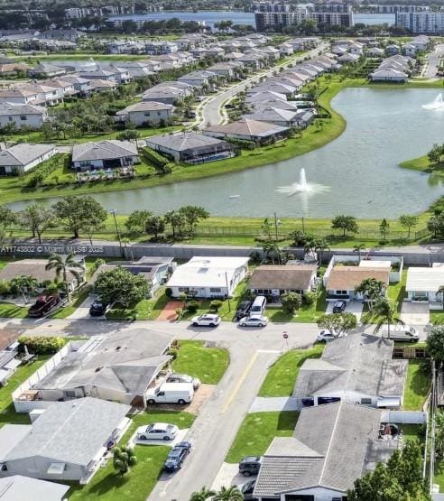 drone / aerial view featuring a water view and a residential view