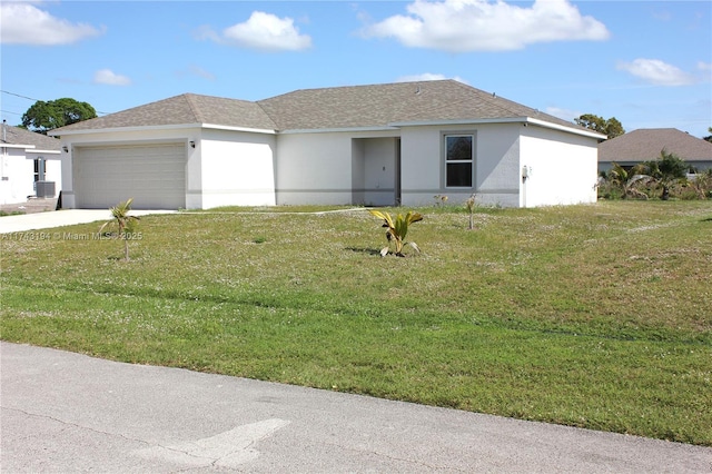 view of front of house featuring a front lawn, cooling unit, and a garage