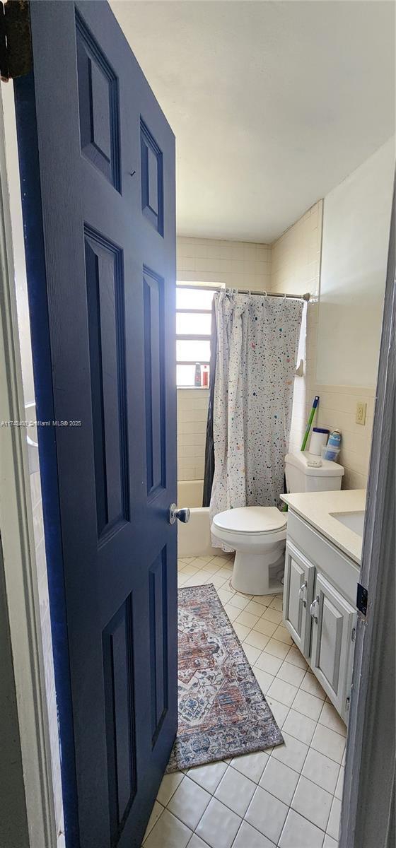 full bathroom featuring vanity, toilet, tile patterned flooring, and shower / bath combo