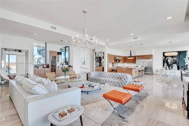 living room featuring an inviting chandelier and sink