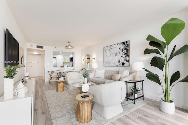 living room with light hardwood / wood-style flooring