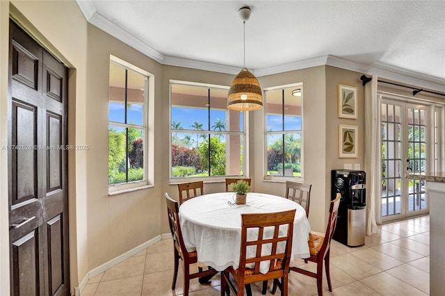 dining area with ornamental molding, french doors, baseboards, and light tile patterned floors