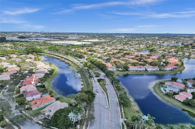 drone / aerial view featuring a water view and a residential view