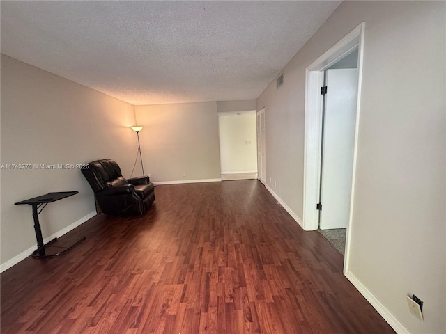 5155 E Sabal Palm Blvd Unit 204, Tamarac, FL 33319 - unfurnished room featuring dark wood-type flooring, a textured ceiling, baseboards, and visible vents