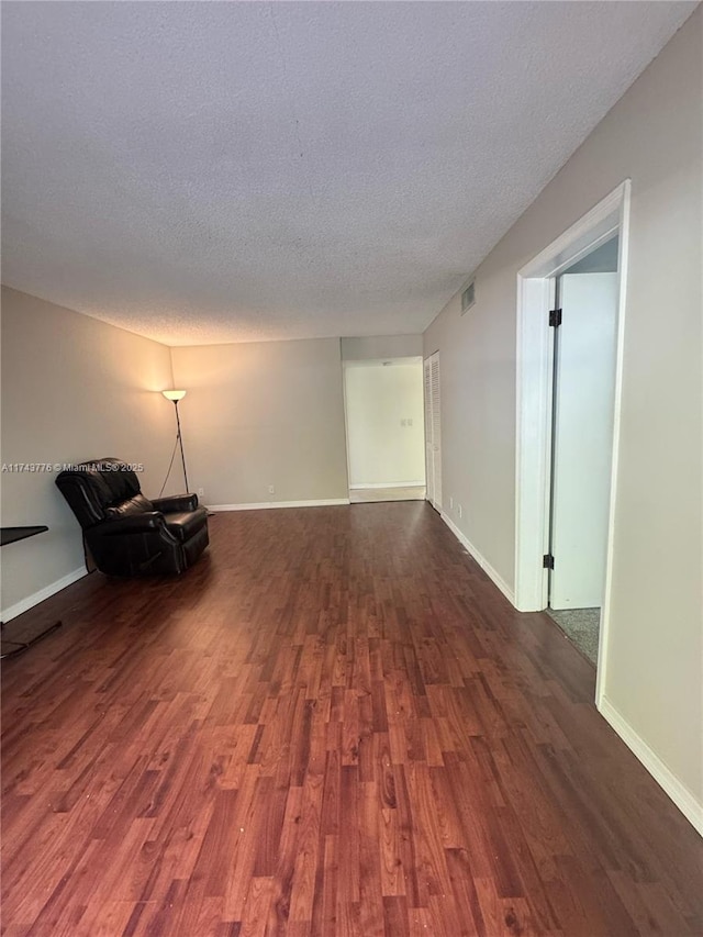 5155 E Sabal Palm Blvd Unit 204, Tamarac, FL 33319 - empty room featuring baseboards, a textured ceiling, and dark wood-style floors