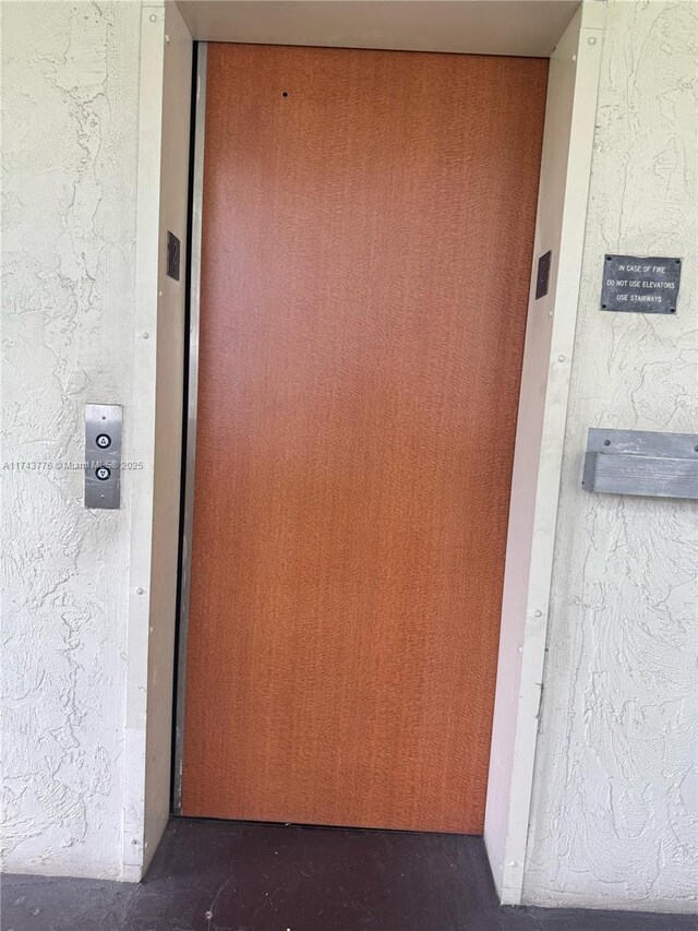 5155 E Sabal Palm Blvd Unit 204, Tamarac, FL 33319 - doorway to property with elevator and stucco siding