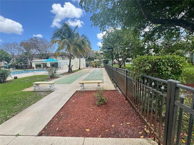 5155 E Sabal Palm Blvd Unit 204, Tamarac, FL 33319 - surrounding community with fence, shuffleboard, and a swimming pool