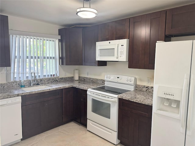 5155 E Sabal Palm Blvd Unit 204, Tamarac, FL 33319 - kitchen with dark brown cabinetry, light stone countertops, white appliances, and a sink