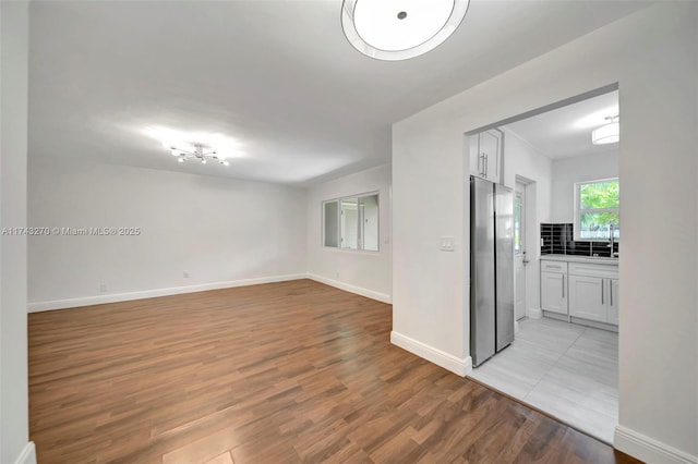 empty room with sink and light wood-type flooring