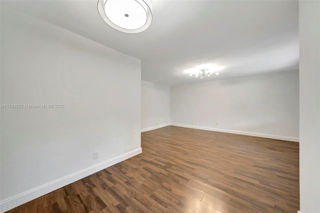 unfurnished room featuring dark wood-type flooring