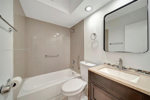 full bathroom with vanity, tiled shower / bath, decorative backsplash, and toilet