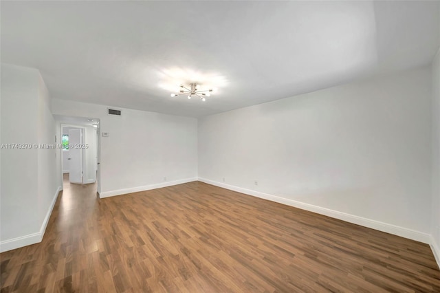 spare room with dark hardwood / wood-style flooring