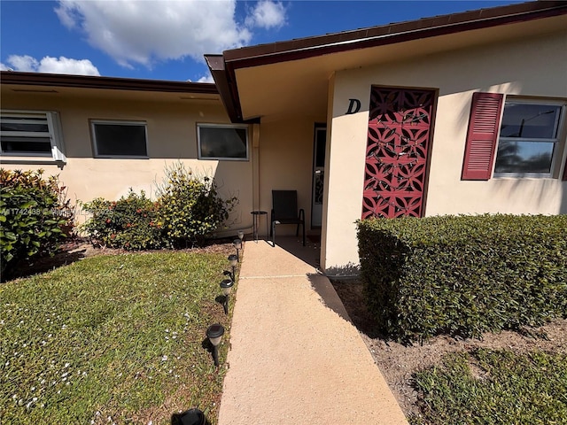 doorway to property with a yard