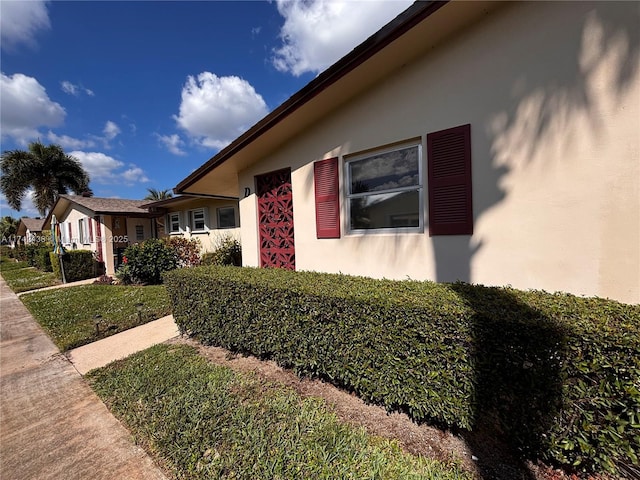 view of side of home featuring a lawn