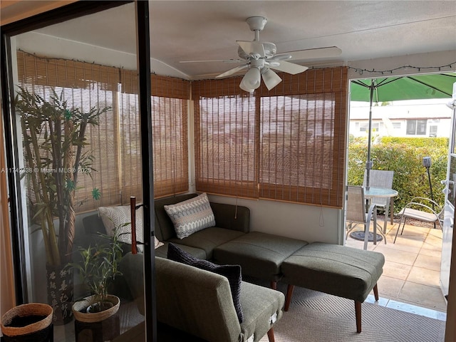 sunroom / solarium featuring ceiling fan