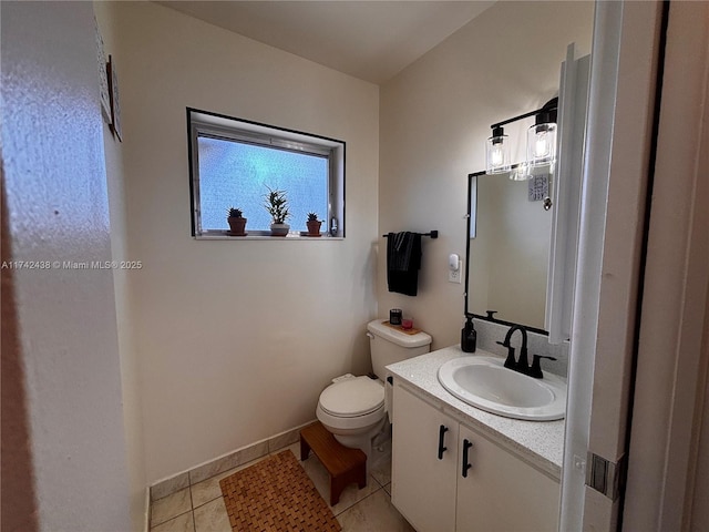 bathroom featuring vanity, tile patterned floors, and toilet