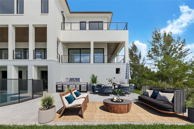 view of patio / terrace featuring outdoor lounge area, a balcony, outdoor dining space, and grilling area