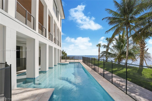 view of swimming pool with a fenced in pool and a water view