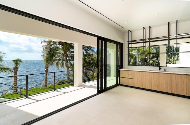 unfurnished sunroom with a water view